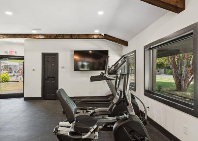 Resident fitness center with cardio equipment at Aldea Manufactured Home Community in Fort Worth, Texas